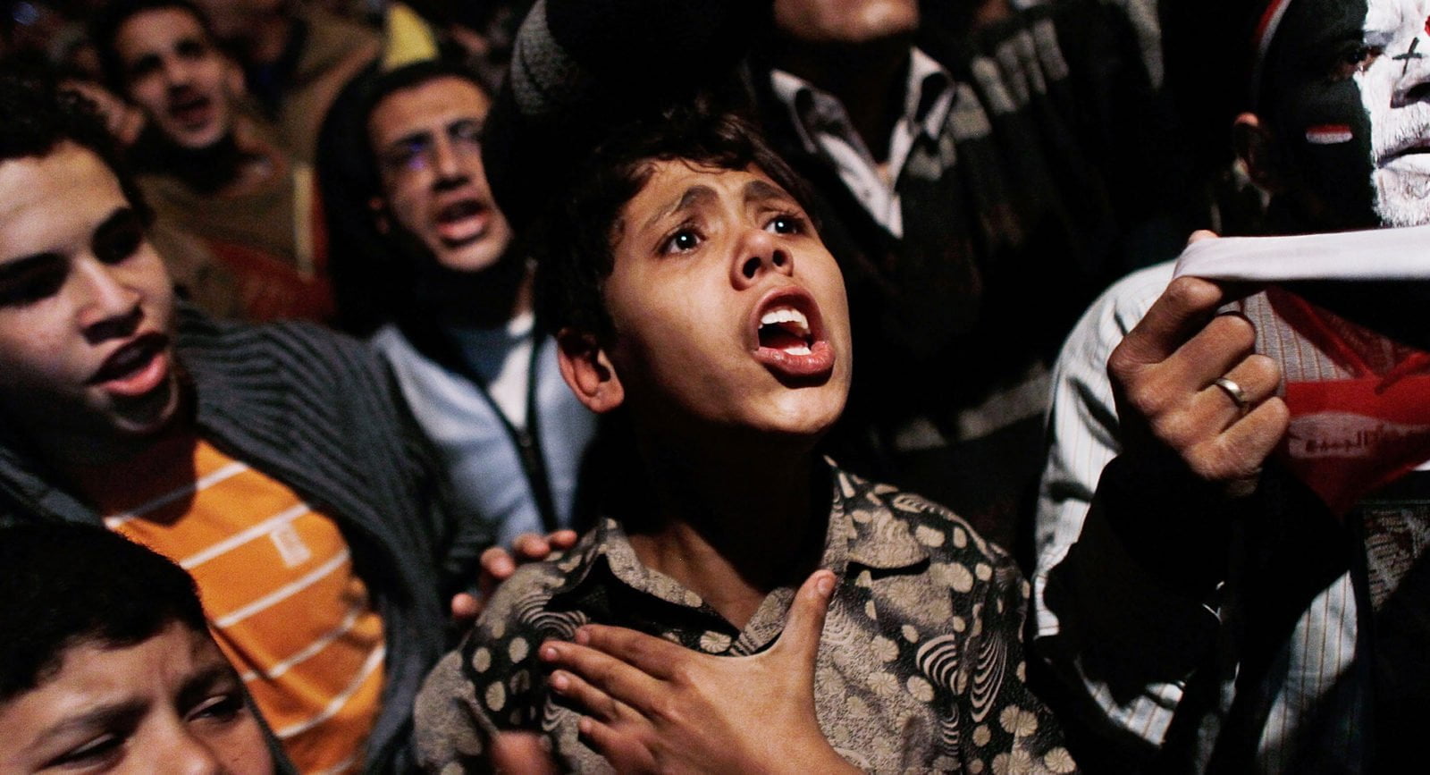 A boy sings in Tahrir Square after Egyptian President Hosni Mubarak steps down on February 11, 2011 in Cairo, Egypt.