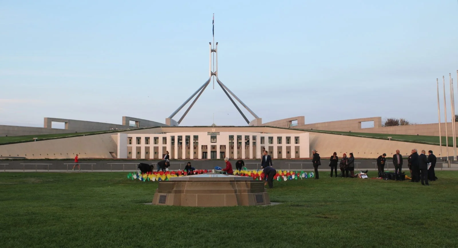 A display of hands planted in the lawns in front of Parliament House in protest of Aboriginal deaths in custody