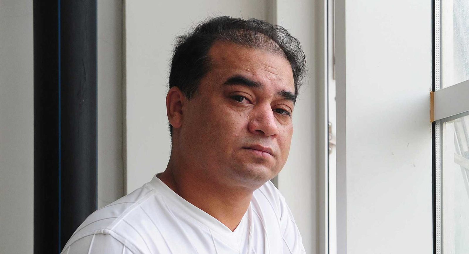 University professor, blogger, and member of the Muslim Uighur minority, Ilham Tohti pauses before a classroom lecture in Beijing on June 12, 2010.