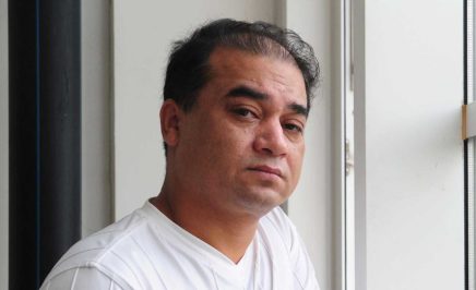 University professor, blogger, and member of the Muslim Uighur minority, Ilham Tohti pauses before a classroom lecture in Beijing on June 12, 2010.