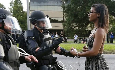 JULY 11 2016 SAVE PRINT LICENSE ARTICLE 'Remarkable' photo of woman facing riot police that may define Black Lives Matter Megan Levy Black Lives Matter reeling after police shootings Dallas shootings compound horror for Americans Who was Micah Johnson, the Dallas shooter? As the lone woman stood in front of a row of riot police in the US, her flowing dress and bare arms in sharp contrast to the officers' armour, she gave off an air of peaceful determination and defiance. Play Mute 0:00 / 0:00 Loaded: 0%Progress: 0% Fullscreen MORE WORLD NEWS VIDEOSPrevious slide Next slide null Black Lives Matter photo goes viral null Video duration 01:03 British actor's ISIL Ariana Grande revenge Myeshia Johnson kisses the casket of her husband, Sgt. La David Johnson during his burial service at Fred Hunter's ... Video duration 01:49 Widow says Trump call 'made me cry' Video duration 00:49 Toys 'R' Us collapse to hit Hasbro ... null Video duration 01:40 Five former US presidents join forces null Video duration 02:13 I don't know how to get through to you: ... null Video duration 01:44 Japanese election risk pays off for Abe null Video duration 01:12 Tillerson: militias in Iraq should 'go ... MORE VIDEOS Black Lives Matter photo goes viral The image of a lone woman in a dress standing up to riot police at a protest in Baton Rouge is being hailed as 