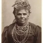 Sepia vintage photo of Fanny Cochrane Smith, Fanny Cochrane Smith wearing wattle in her hair and traditional shell necklace.