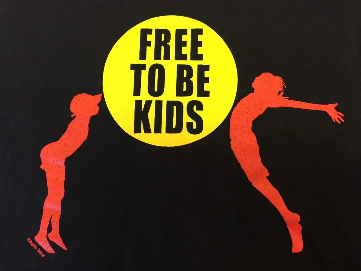 A silhouette of two kids jumping in the air, one on each side of a yellow circle which has the wording 