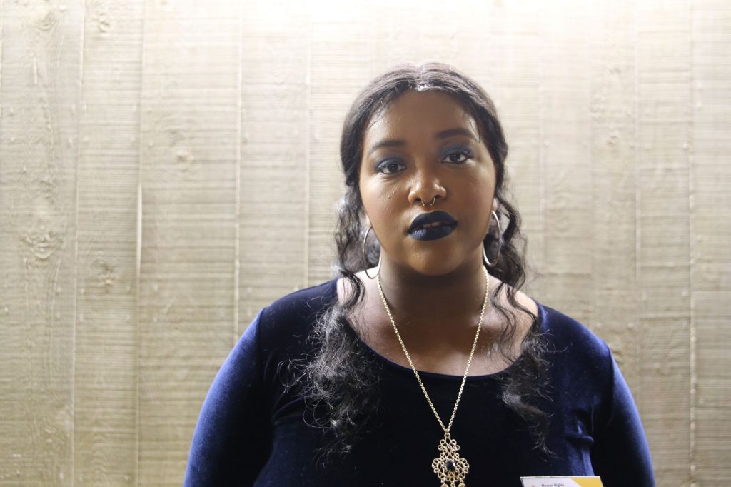 Woman with dark skin and wearing blue lipstick