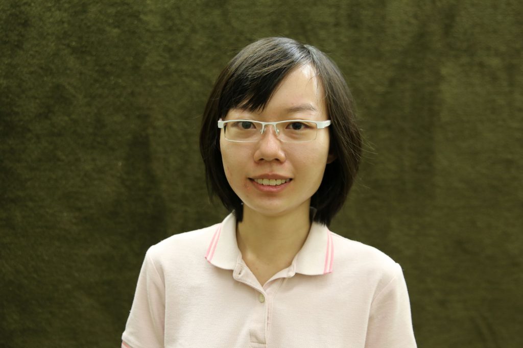 Woman of Asian descent with a bob haircut and glasses
