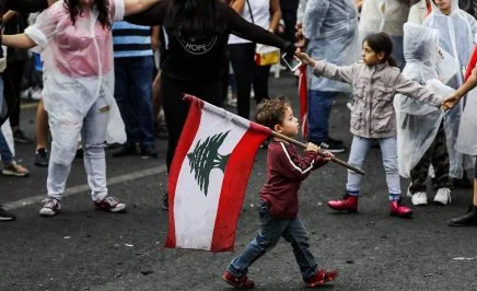Young boy carries flag
