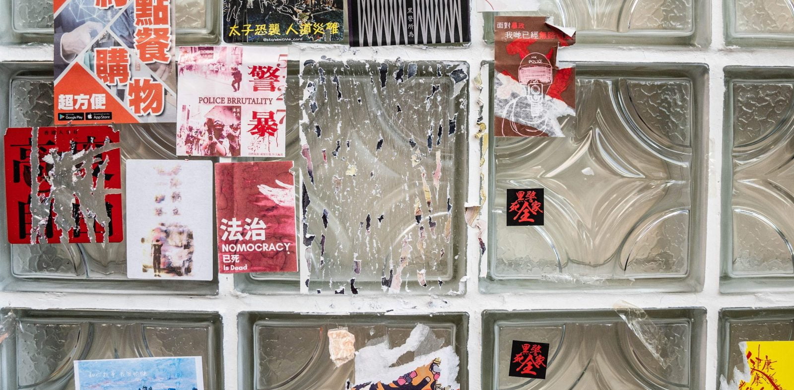 Stickers with messages in support of the pro democracy movement are scraped from a wall outside a restaurant in Hong Kong