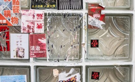 Stickers with messages in support of the pro democracy movement are scraped from a wall outside a restaurant in Hong Kong