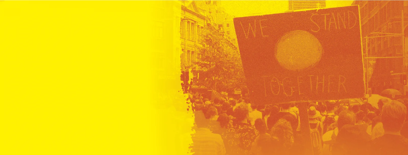 Sign reading 'We Stand Together' on Aboriginal Flag at a rally