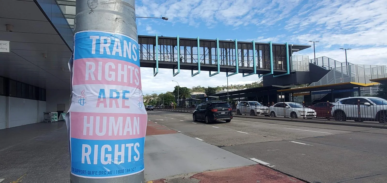 Poster taped to a pole on the street reads 