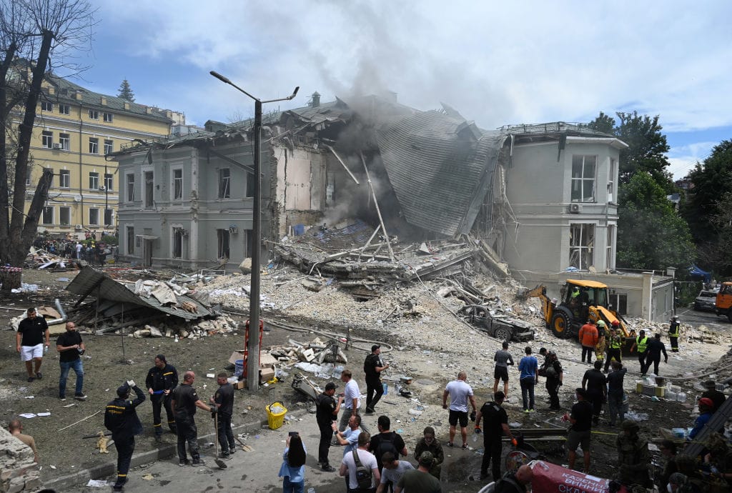 Ukrainian rescuers of emergency services and police officers are working at the site of Okhmatdyt children's hospital damaged by Russian missiles in Kyiv, Ukraine, on July 8, 2024, amid Russia's invasion of Ukraine. At least 27 people are being reported killed and more than 100 injured in a massive Russian missile strike attack on Kyiv this morning, according to local media. (Photo by STR/NurPhoto via Getty Images)